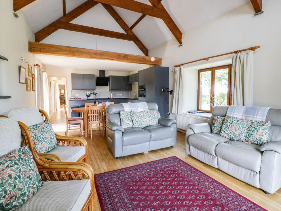 Open-plan living room with dining table and sofas