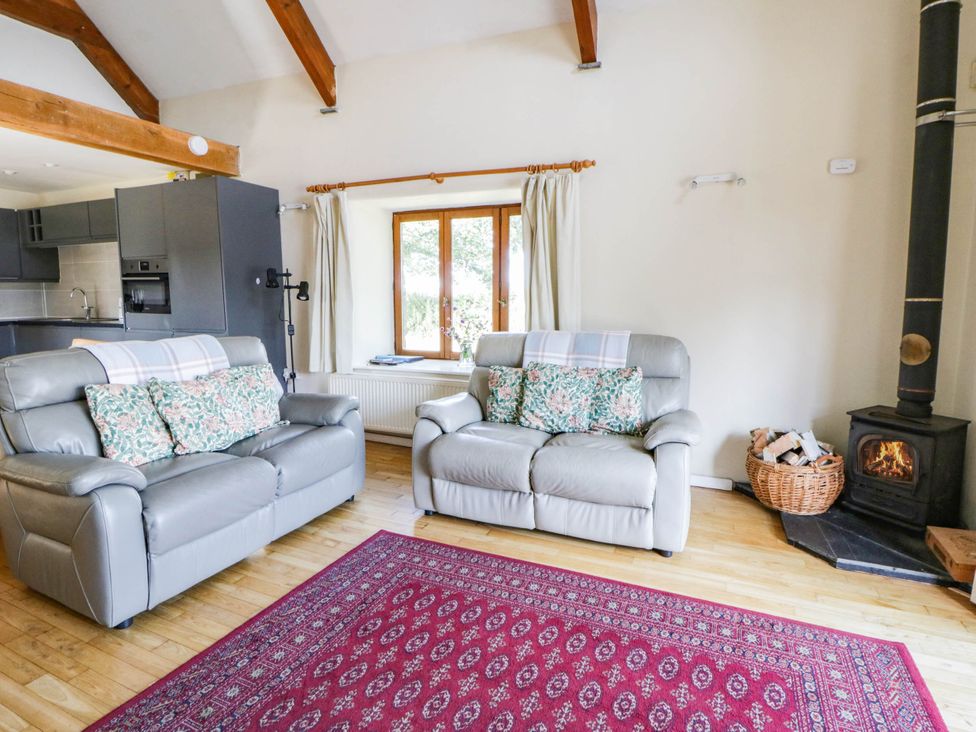 Living room with two sofas and a woodburning stove