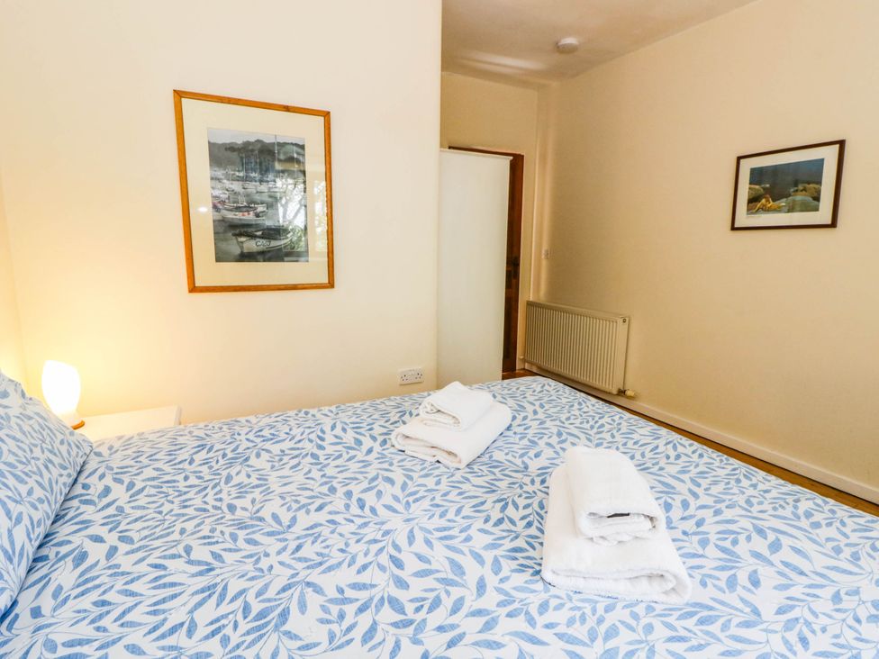 Bedroom with bed made up and towels