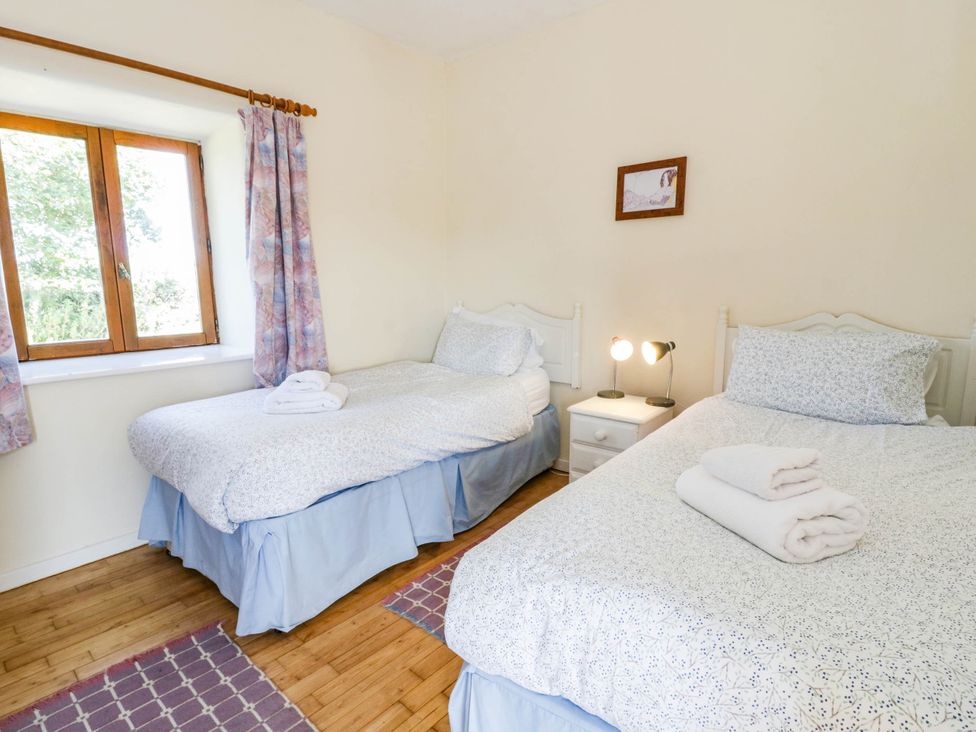 Twin bedroom with two beds and a window
