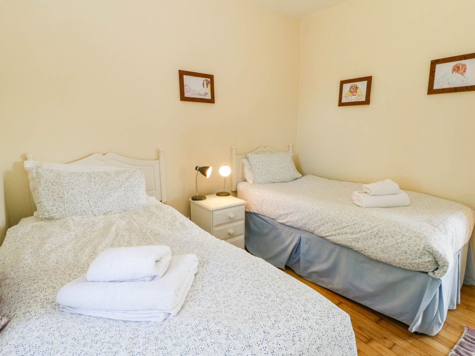 Twin bedroom with bedside lamp