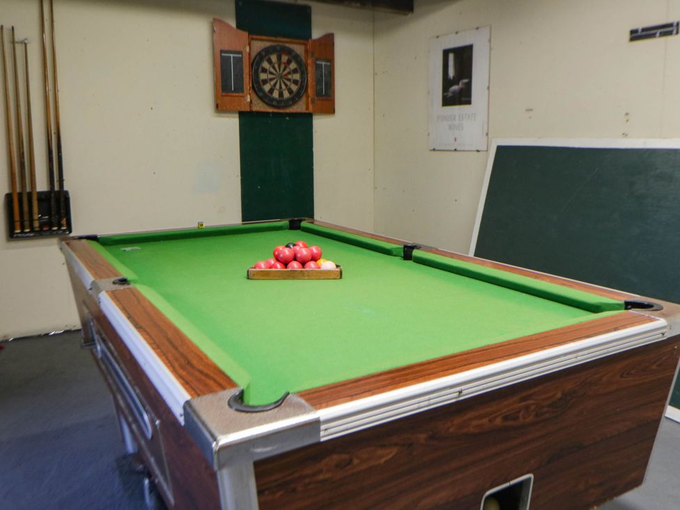 Pool table and dartboard in the games room