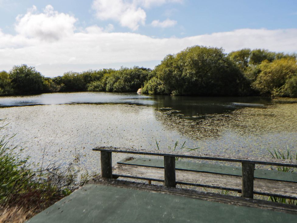 View across the lake with a bench in the foreground