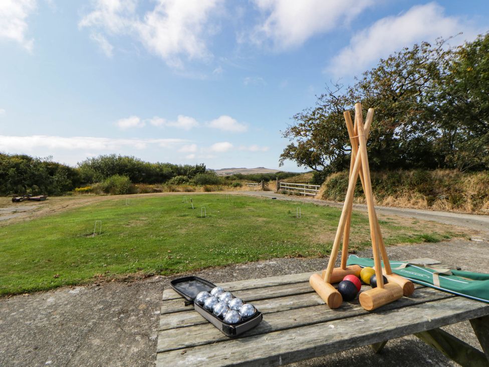 Croquet mallets and balls set out on an outdoor table